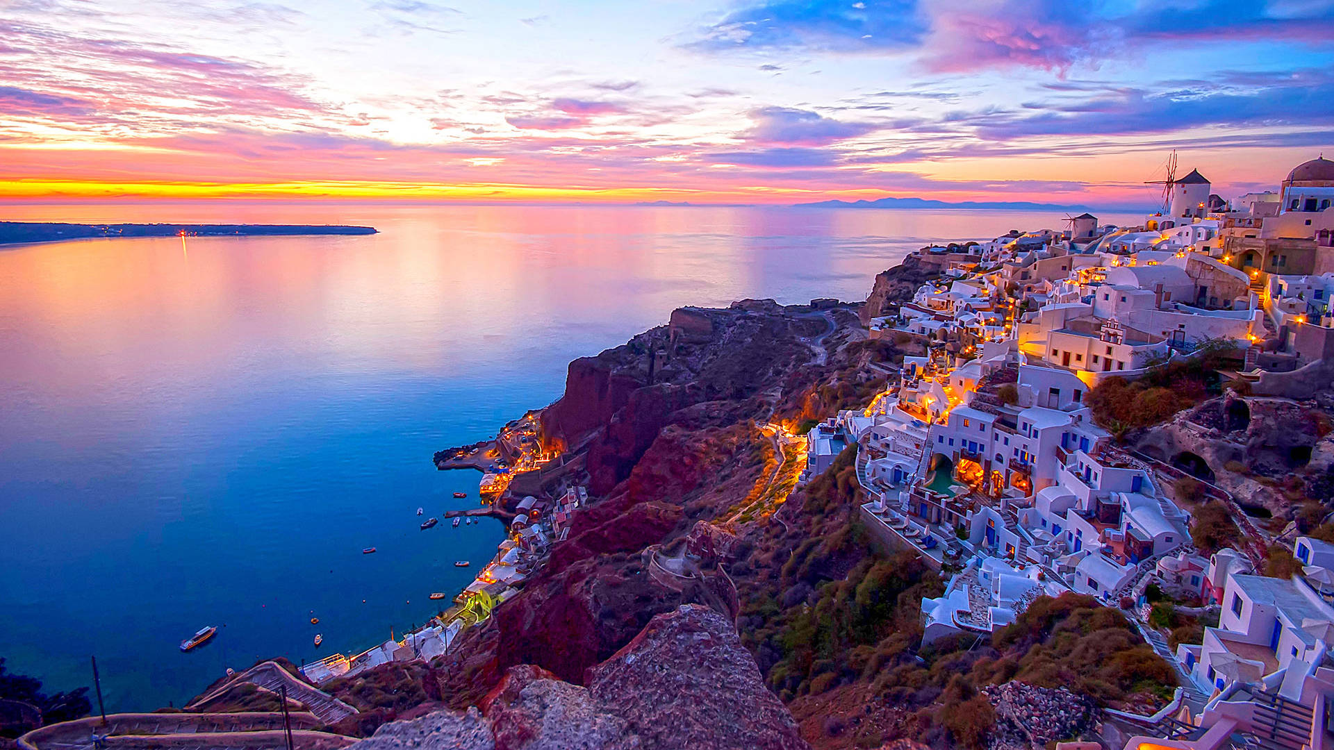 
Panoramic view of mesmerizing Santorini: Infinite blue of the sea meets the lush green craters of the island, creating an unforgettable image.