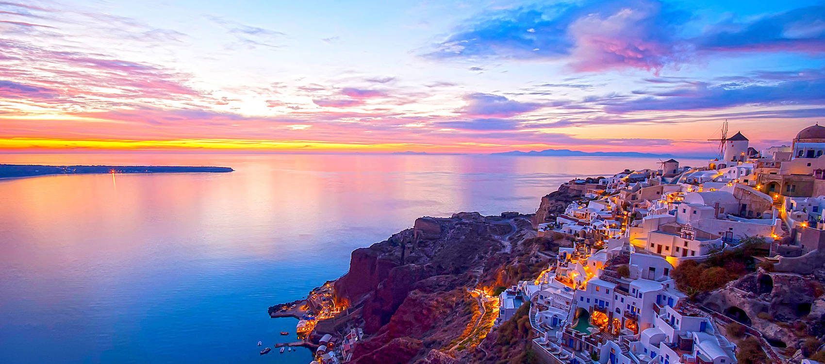 
Panoramic view of mesmerizing Santorini: Infinite blue of the sea meets the lush green craters of the island, creating an unforgettable image.