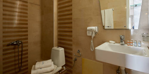 
Santorini View Hotel bathroom with shower and bath amenities