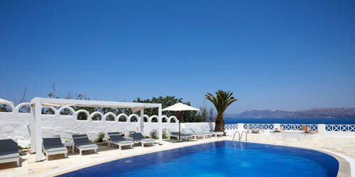 
Santorini View Hotel swimming pool with subeds, sea view and trees