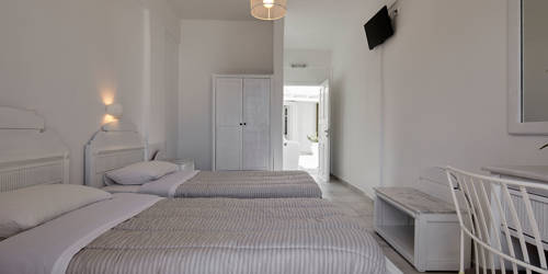 
Santorini View Hotel bedroom with two single beds and white furniture