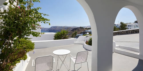 
Santorini View Hotel patio with flowers, table seats and sea view