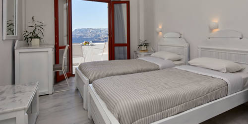 
Santorini View Hotel bedroom with two single beds and balcony with caldera sea view