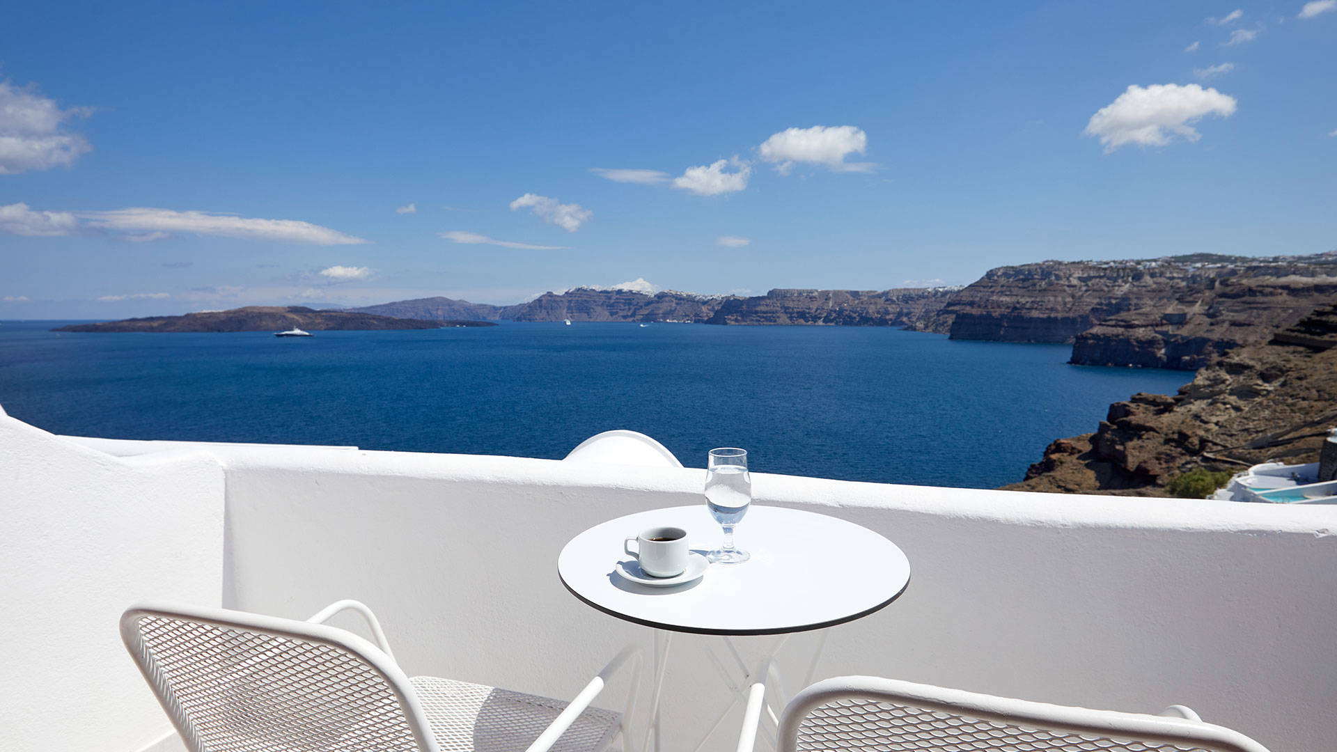 
Santorini sea View Hotel white table seats with greek coffee and glasses of water