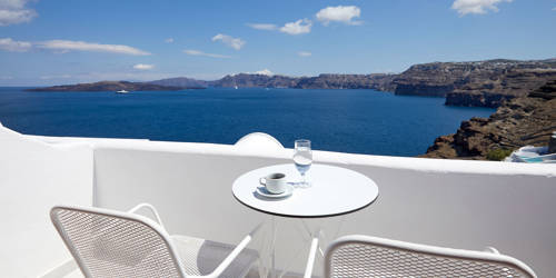 
Santorini sea View Hotel white table seats with greek coffee and glasses of water