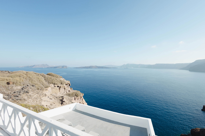 Breathtaking caldera view from a Santorini View Hotel's terrace perched on the cliffs overlooking the Aegean