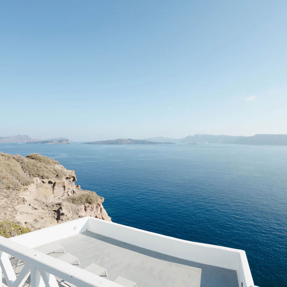 Breathtaking caldera view from a Santorini View Hotel's terrace perched on the cliffs overlooking the Aegean