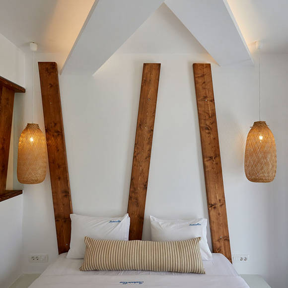 Bright bedroom in Superior Double room with wooden accents, woven pendant lamps and soft beige bedding
