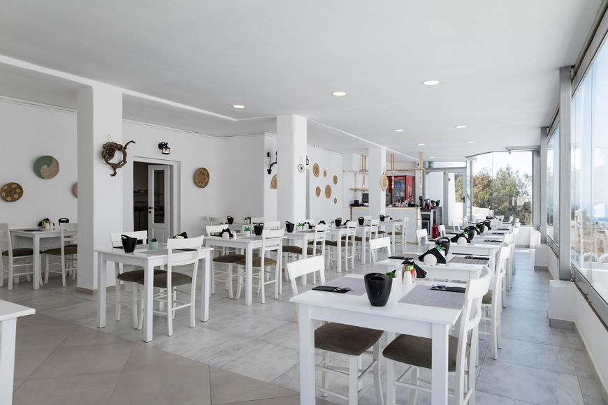 Bright Santorini View Hotel restaurant with white decor and panoramic view windows