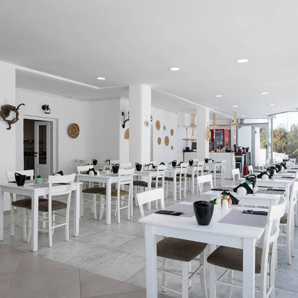 Bright Santorini View Hotel restaurant with white decor and panoramic view windows