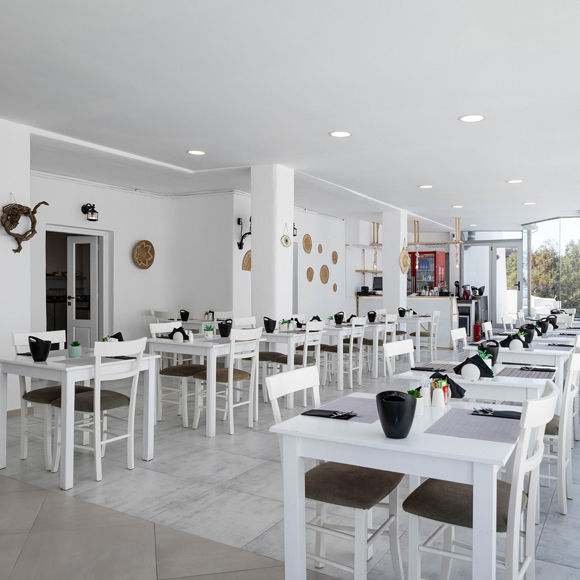 Bright Santorini View Hotel restaurant with white decor and panoramic view windows