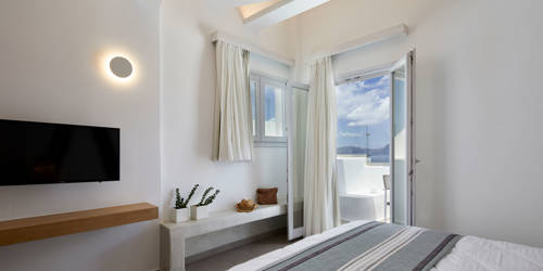 
Santorini View Hotel bedroom with double bed, tv, pots with flowers and balcony with aegean sea view 
