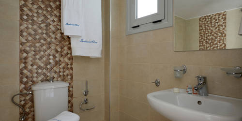 
Santorini View Hotel with sink, white towels and toilet