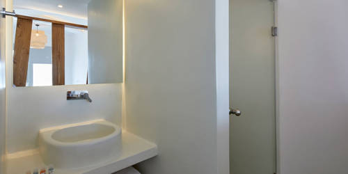 
Santorini View Hotel bathroom with white sink, bath amenities and white towels