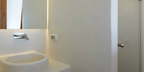 
Santorini View Hotel bathroom with shower, bath amenities and white towels