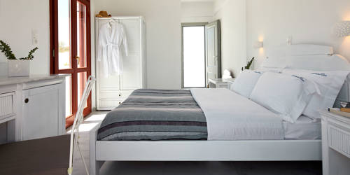 
Santorini View Hotel big bedroom with king size bed, white and grey linen and white furnitures