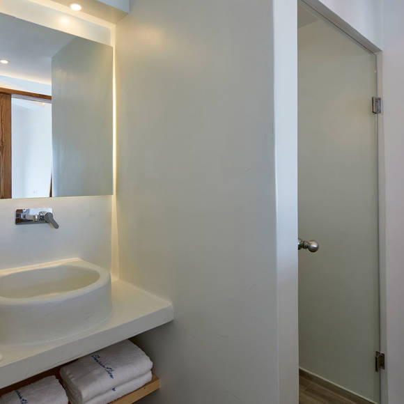 Contemporary bathroom of Deluxe double room with illuminated mirror, built-in sink and natural wood accents