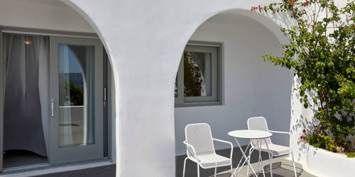 
Santorini View Hotel suite with terrace, flowers and table seats