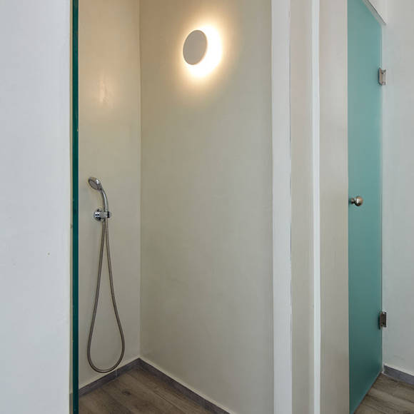 Minimalist walk-in shower with rainfall head, soft lighting and wooden floor tiles in Superior Double room
