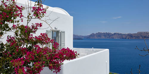 
Santorini View Hotel with white balcony and bougainvillea flowers, with endless sea and caldera views