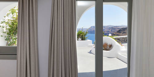 
Santorini View Hotel room with sea view doors and curtains