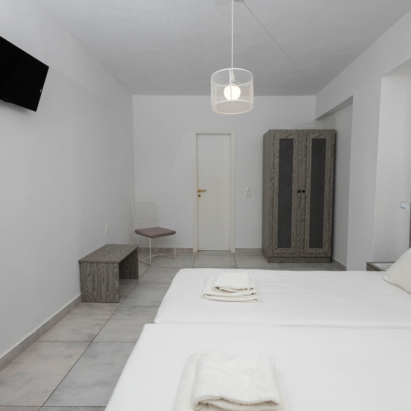 Standard Room with twin beds and modern grey furniture at Santorini View Hotel Akrotiri