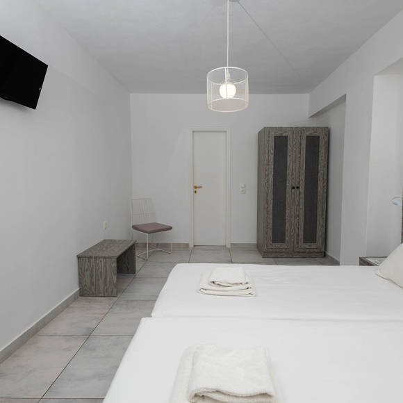 Standard Room with twin beds and modern grey furniture at Santorini View Hotel Akrotiri