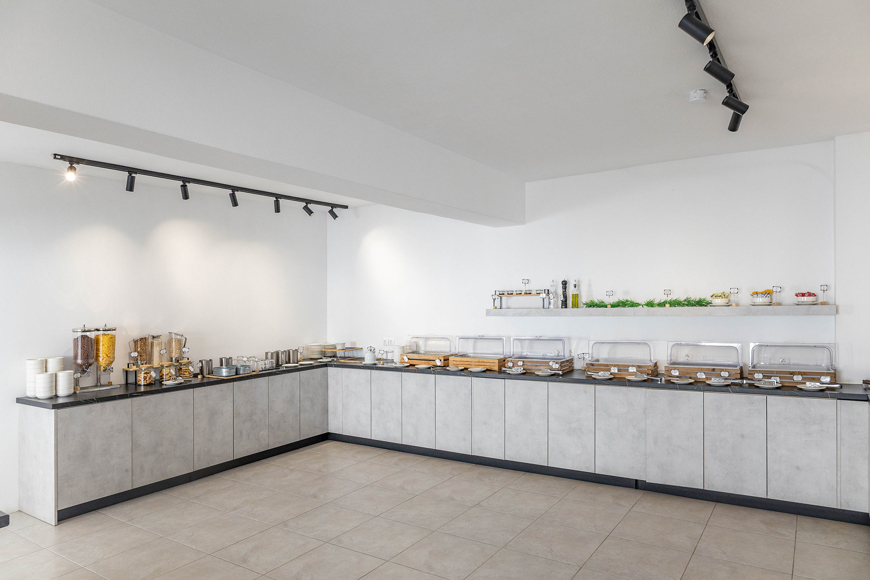 Santorini View Hotel breakfast buffet with modern counters offering a variety of cereals and baked goods