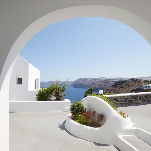 Elegant Suite terrace at Santorini View Hotel with whitewashed arches, vibrant plants, and panoramic caldera view