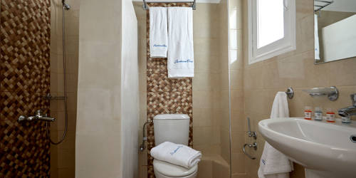 
Santorini View Hotel with shower, sink, toilet and brown tiles