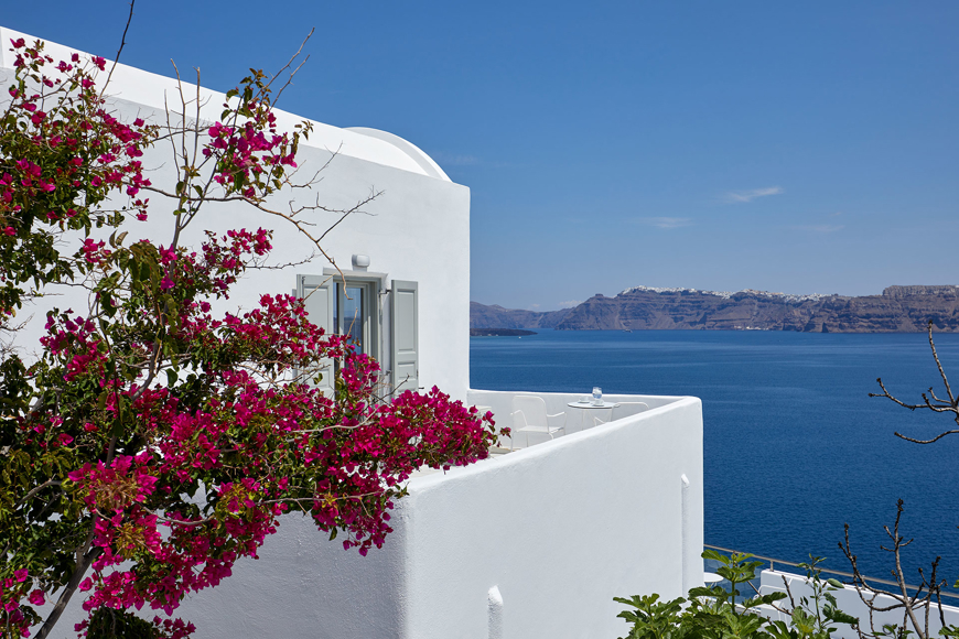 Exterior view of the Junior Suite at Santorini View Hotel, with Cycladic architecture, vibrant bougainvillea and sea view