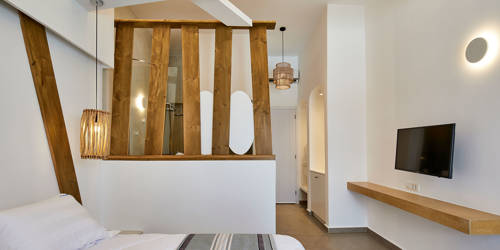 
Santorini View Hotel double bed with wooden decoration and tv