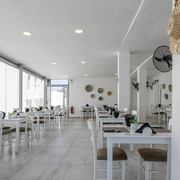 Stylish Santorini View Hotel restaurant with interior, modern furniture, and large windows