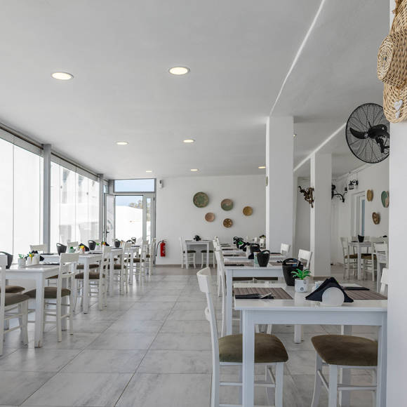 Stylish Santorini View Hotel restaurant with interior, modern furniture, and large windows