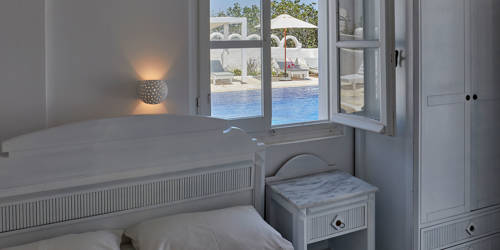 
Santorini View Hotel bedroom with double bed and pool view