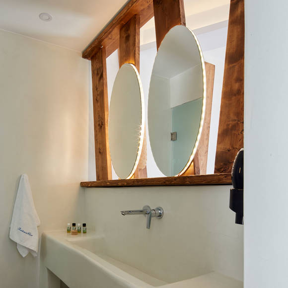 Modern bathroom of the Superior Double room at Santorini View Hotel with elegant wooden mirrors