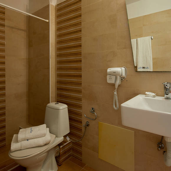 Modern bathroom with shower and amenities in the Classic Double room at Santorini View Hotel