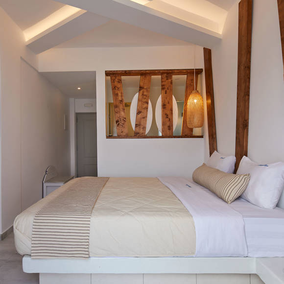 Warm, inviting bedroom with soft lighting, natural wood accents and cozy neutral bedding