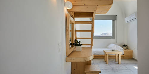 
Santorini View Hotel single bed downstairs, with wooden furniture, window and air-condition