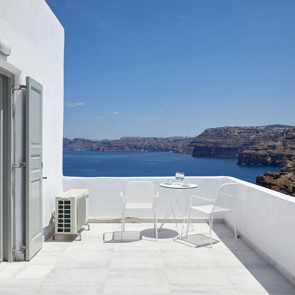 Spacious private terrace of the Junior Suite at Santorini View Hotel featuring white furniture and caldera sea views