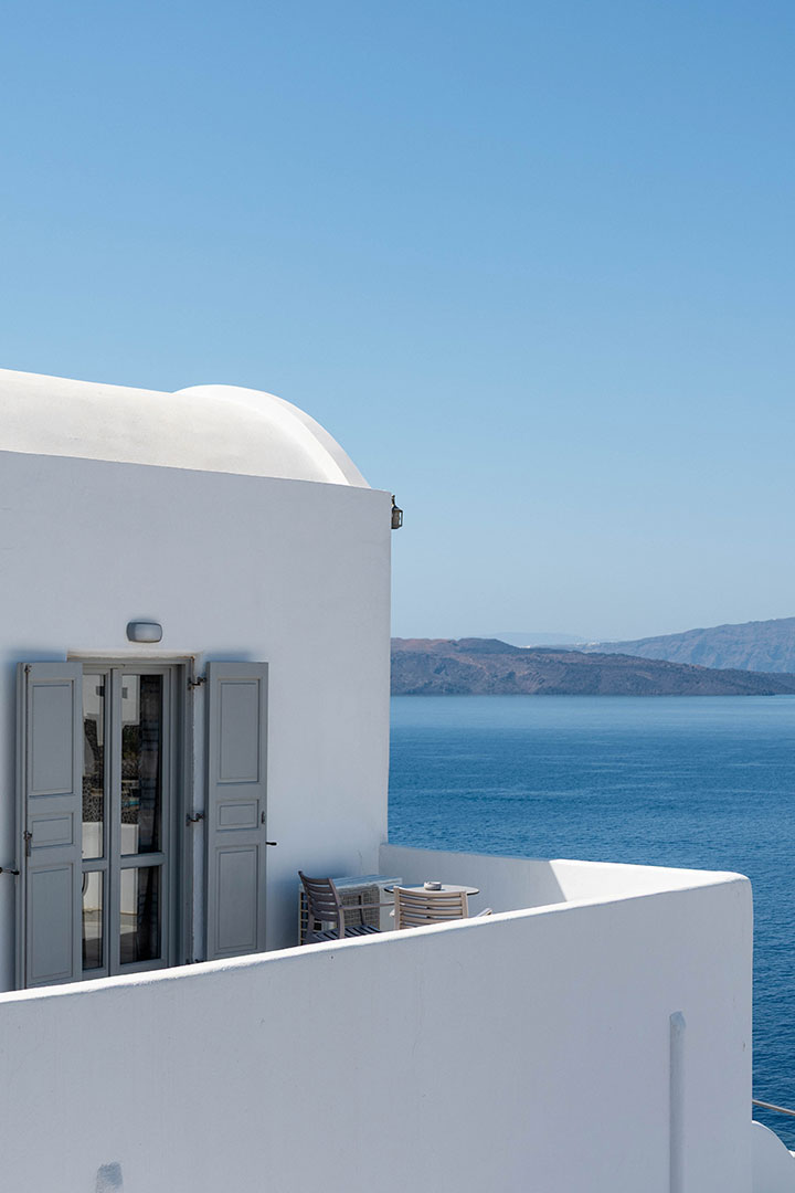 Elegant white terrace with sea view at Santorini View Hotel overlooking the Caldera in Akrotiri