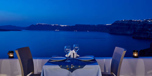 
Santorini View Hotel caldera view restaurant, exterior table seats at night 