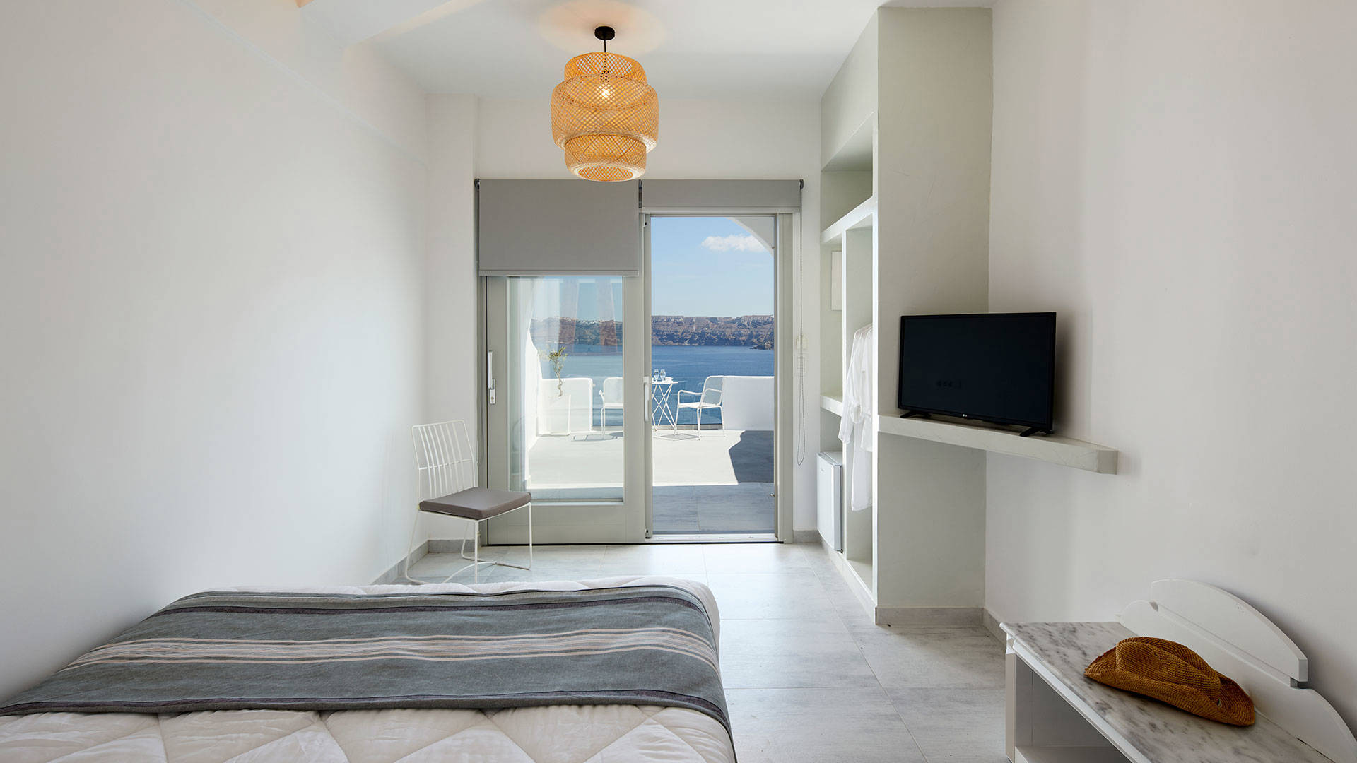 
Santorini View Hotel bedroom with double bed and tv, with balcony with aegean sea view
