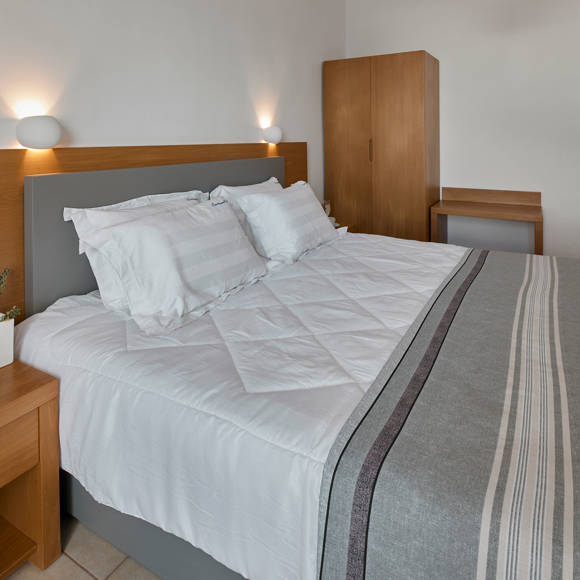 Comfortable Classic Double room interior with king bed and modern decor at Santorini View Hotel