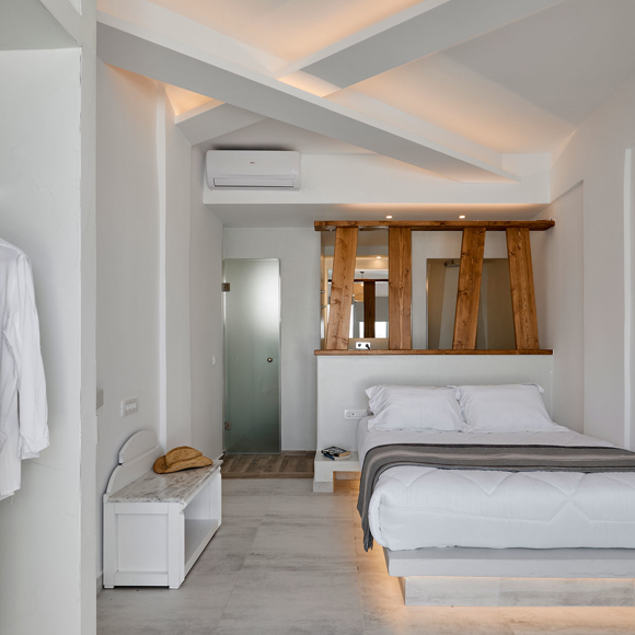 Spacious Deluxe Double bedroom with modern design, wooden details and soft ambient lighting